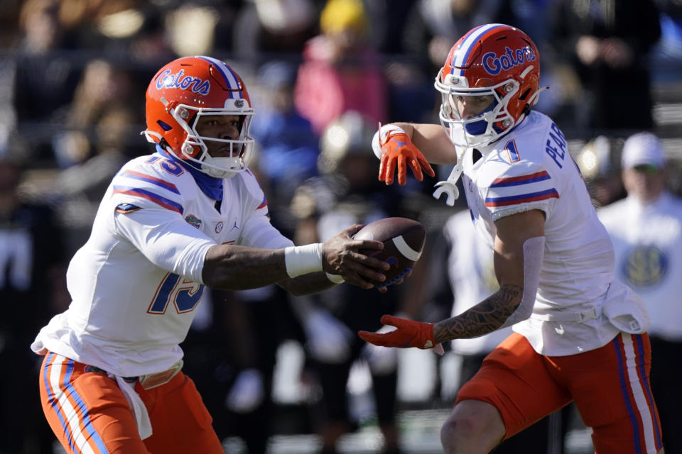 Florida quarterback Anthony Richardson (15) hands off to Ricky Pearsall (1) in the first half of an NCAA college football game against Vanderbilt Saturday, Nov. 19, 2022, in Nashville, Tenn. (AP Photo/Mark Humphrey)