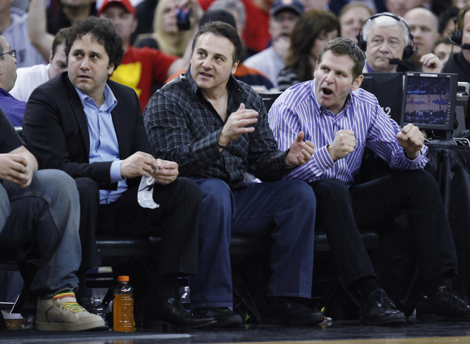 FILE - In this Feb. 28, 2011 file photo, Sacramento Kings owners George, Gavin and Joe Maloof, left to right, cheer on their team against the Los Angeles Clippers during the second half of an NBA basketball game in Sacramento, Calif. The city of Sacramento, the NBA and the Kings have announced a tentative deal to finance a new arena that would keep the team in California's capital. Sacramento Mayor Kevin Johnson, NBA Commissioner David Stern and the Maloof family, which owns the Kings, announced Monday in Orlando, Fla., that an agreement had been reached. (AP Photo/Steve Yeater, file)