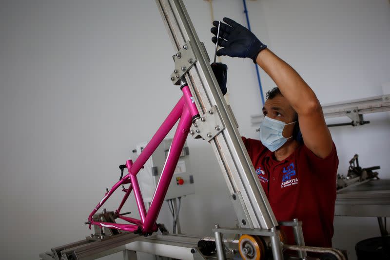 A worker is seen preforming tests with a bicycle at the Abimota in Agueda