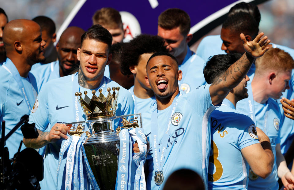 <p>Soccer Football – Premier League – Manchester City vs Huddersfield Town – Etihad Stadium, Manchester, Britain – May 6, 2018 Manchester City’s Ederson and Gabriel Jesus celebrates with the trophy after winning the Premier League title REUTERS/Phil Noble EDITORIAL USE ONLY. No use with unauthorized audio, video, data, fixture lists, club/league logos or “live” services. Online in-match use limited to 75 images, no video emulation. No use in betting, games or single club/league/player publications. Please contact your account representative for further details. </p>