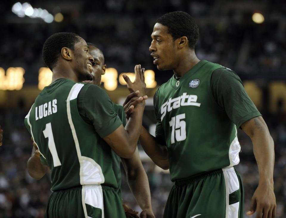 MSU's Kalin Lucas, Travis Walton and Durrell Summers, left to right,  celebrate late in the game against Connecticut   during their Final Four win Saturday April 4, 2009.