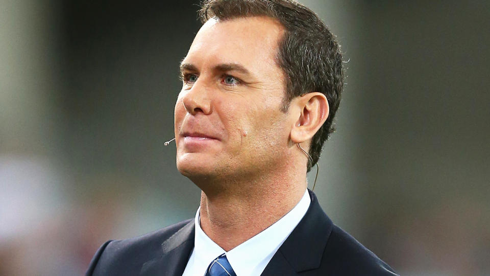 Wayne Carey is pictured working commentary during an AFL game.