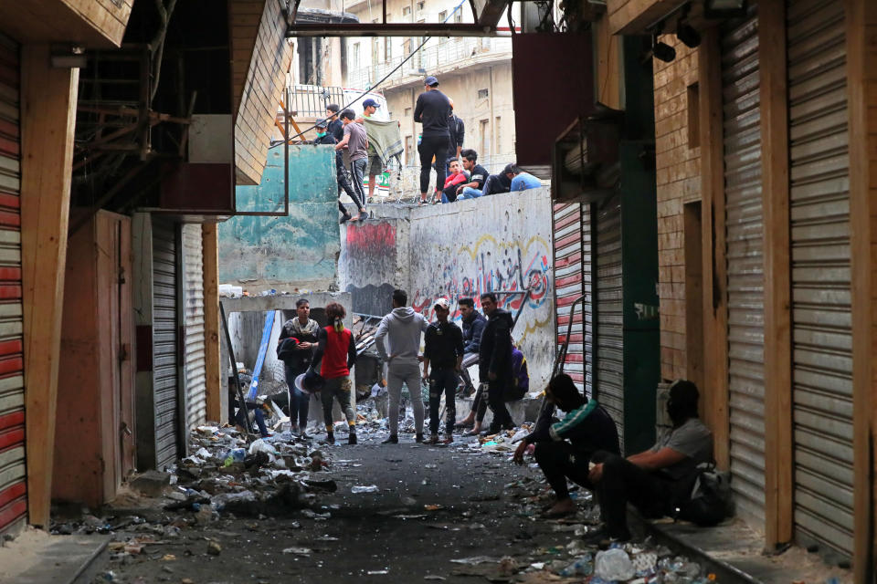 Anti-government protesters stage a sit-in on Rasheed Street, in Baghdad, Iraq, Sunday, Dec. 1, 2019. Iraq’s parliament approved the resignation of Prime Minister Adel Abdul-Mahdi, amid ongoing violence and anti-government demonstrations. (AP Photo/Khalid Mohammed)