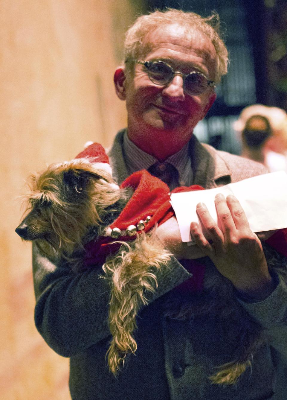 In this undated photo provided by Festival Ballet Providence, Misha Djuric, the ballet company's artistic director, holds Archie, his Yorkshire Terrier, who has performed in more than 125 performances of "The Nutcracker." Festival Ballet Providence has announced that its beloved 19-year-old Nutcracker dog is retiring from the stage. The company plans auditions for the next Nutcracker dog on Dec. 2, 2018, at their studios on Hope Street, in Providence, R.I. (Dylan Giles/Festival Ballet Providence via AP)