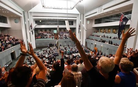 Members celebrate before the passing of the Marriage Amendment Bill in the House of Representatives at Parliament House in Canberra December 7, 2017. AAP/Mick Tsikas/via REUTERS