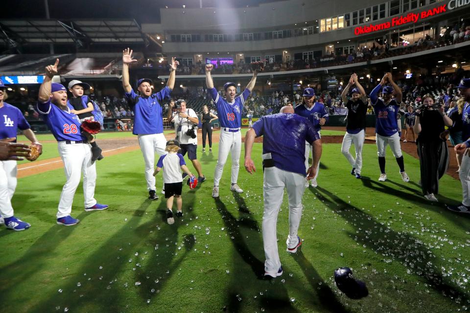 Members of the Oklahoma City Dodgers celebrate after winning a game in the Pacific Coast League Championship Series. The team is one of many minor league franchises owned by Diamond Baseball Holdings.