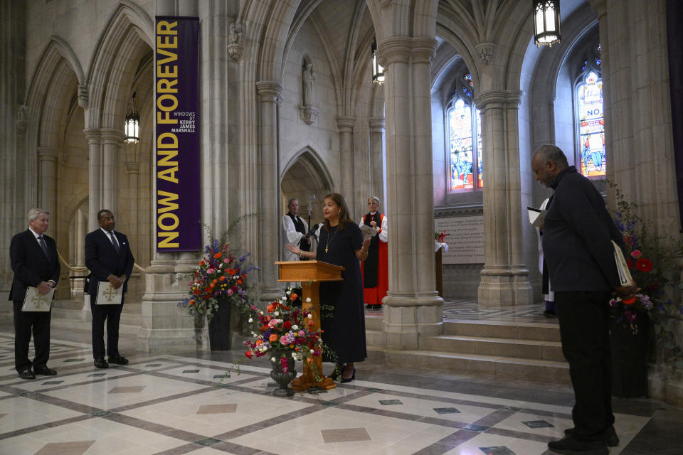 Elizabeth Alexander, center, reads her poem "American Song" during an unveiling and dedication ceremony at the Washington National Cathedral for the new stained-glass windows with a theme of racial justice, Saturday, Sept. 23, 2023, in Washington. (AP Photo/Nick Wass)