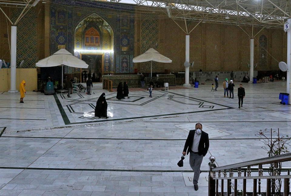 Shiite pilgrims wear masks when visiting the shrine of Imam Ali in Najaf, Iraq, Tuesday, 25, 2020. The Health Ministry said four new cases of coronavirus were diagnosed in the northern province of Kirkuk. It said the afflicted were members of an Iraqi family who had returned from a recent trip to Iran. Iraq announced the discovery of the first coronavirus case in the country on Monday in Najaf. Iraq had earlier closed its border with Iran to Iranian nationals but apparently Iraqis can still cross the boundary. (AP Photo/Anmar Khalil)