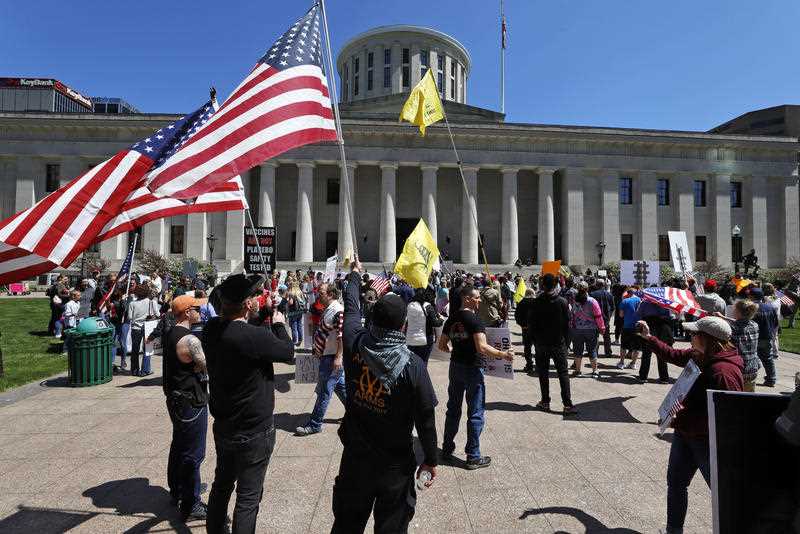 Protesters gather outside of the Ohio State House in Columbus, Ohio.