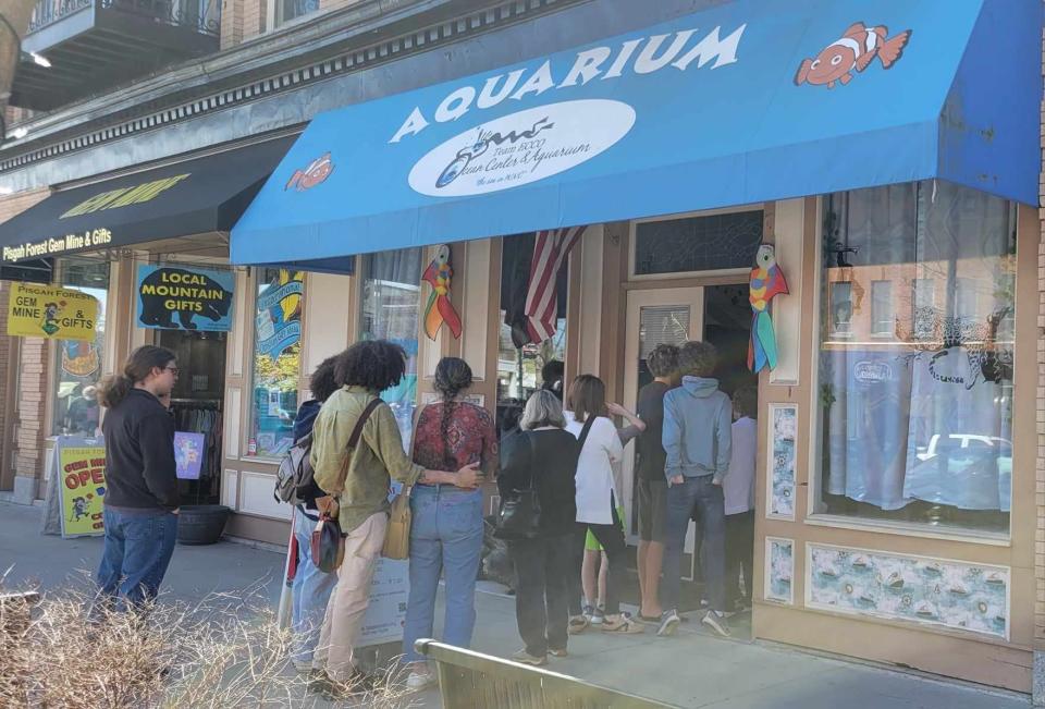 People are in line on March 13 as they wait to get in to the Aquarium and Shark Lab by Team ECCO.