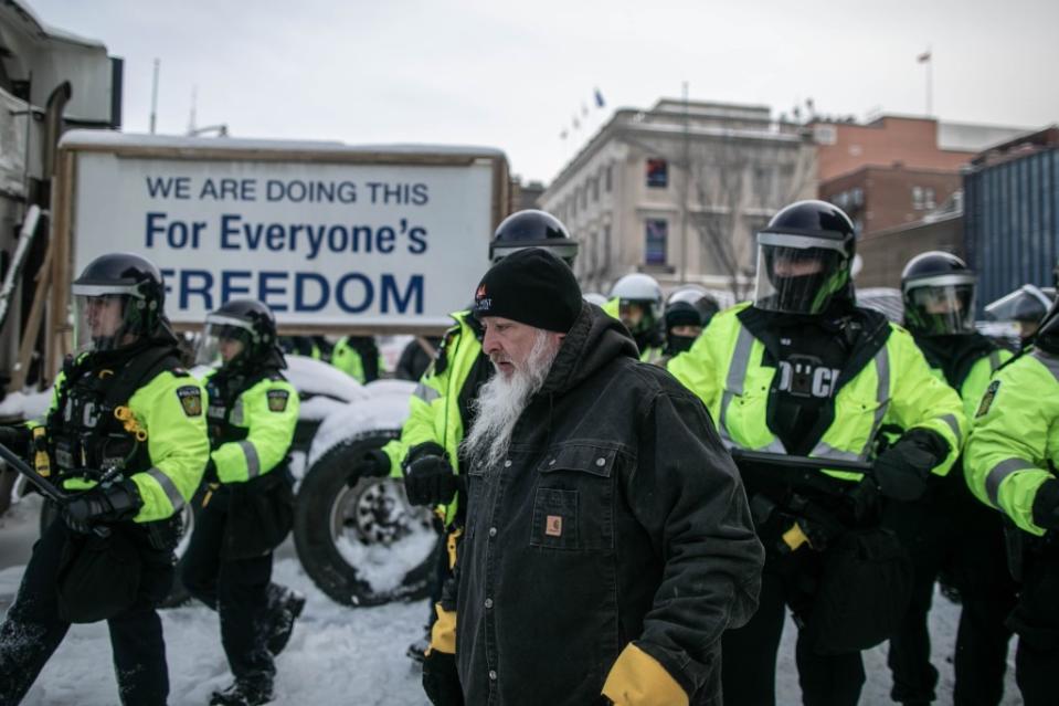 OTTAWA, CANADA - FEBRUARY 19: Police forces clash with protesters in Ottawa city center as they clear a protest by Canadian truck drivers over Covid-19 restrictions which has led to gridlock in Ottawa, Canada, 19 February, 2022. (Photo by Amru Salahuddien/Anadolu Agency via Getty Images)