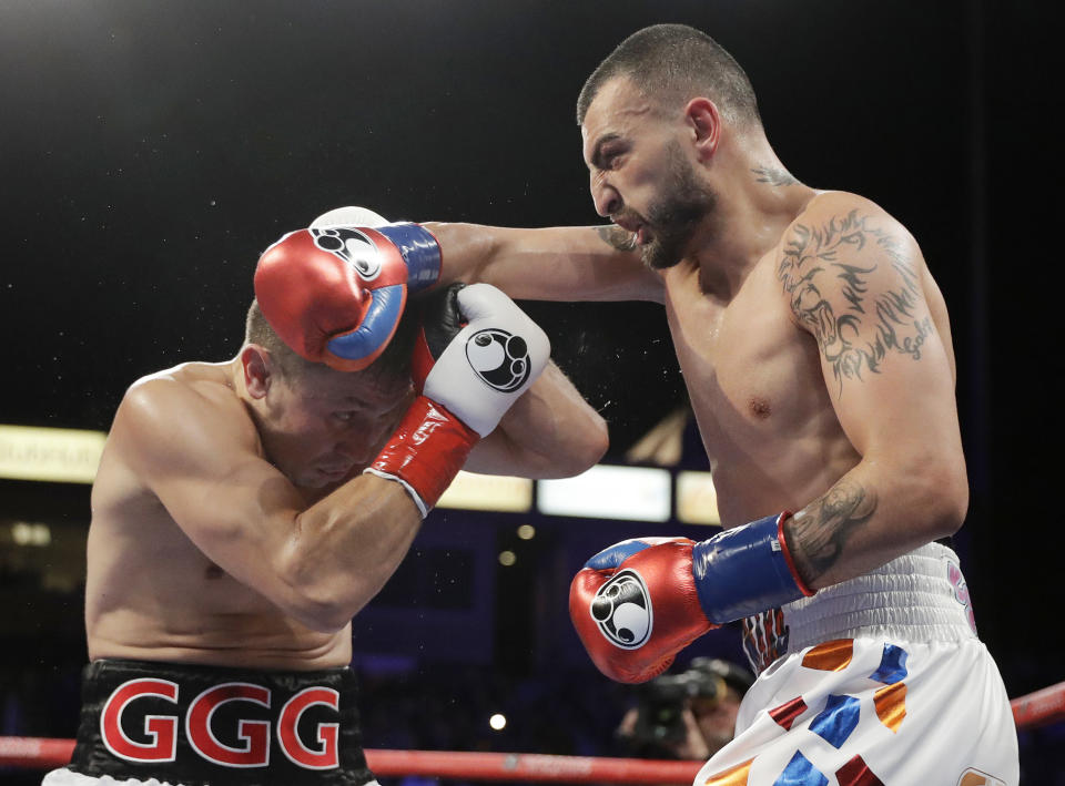 Gennady Golovkin (L) tries to avoid a right from Vanes Martirosyan during their middleweight title boxing match Saturday, May 5, 2018, in Carson, California. (AP Photo)