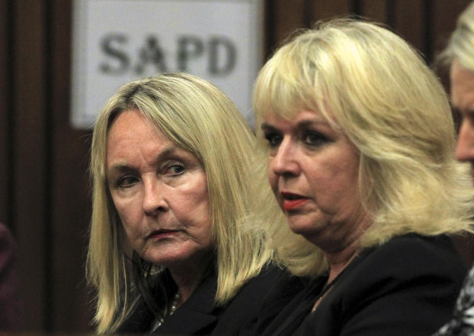 June Steenkamp, the mother of Reeva Steenkamp, left, and an unidentified woman sit inside the high court prior to the start of a murder trial in Pretoria, South Africa, Monday, March 3, 2014. Oscar Pistorius is charged with murder with premeditation in the shooting death of girlfriend Reeva Steenkamp in the pre-dawn hours of Valentine's Day 2013. (AP Photo/Themba Hadebe, Pool)