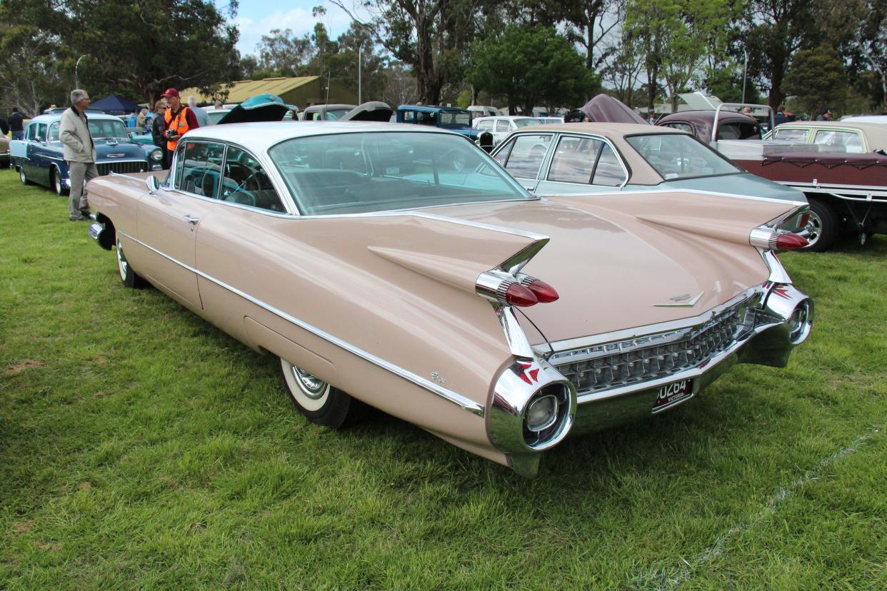 Dusty pink 1959 Cadillac Series 63 Coupe deVille at an outdoor car show