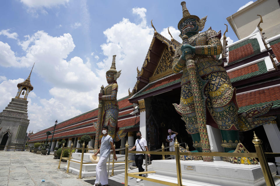 Tourists visit Grand Palace in Bangkok, Thailand, Friday, June 17, 2022. Summer travel is underway across the globe, but a full recovery from two years of coronavirus could last as long as the pandemic itself. (AP Photo/Sakchai Lalit)