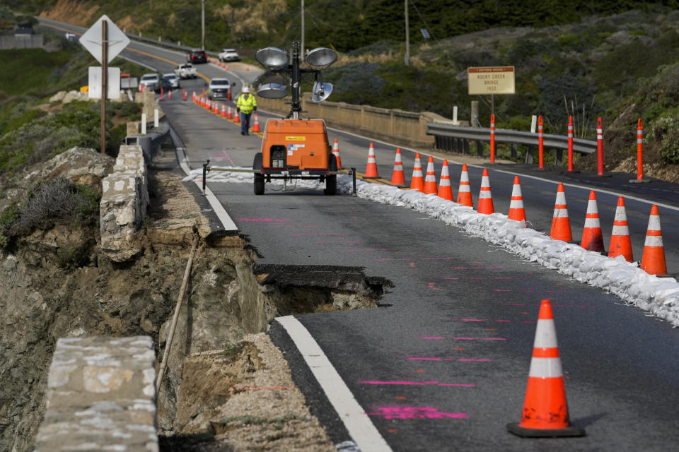 The collapsed section of the southbound lane of Highway 1 at Rocky Creek Bridge is marked off by cones Thursday, April 4, 2024, in Big Sur, Calif. The break has caused the closure of the scenic road. (AP Photo/Godofredo A. Vásquez)