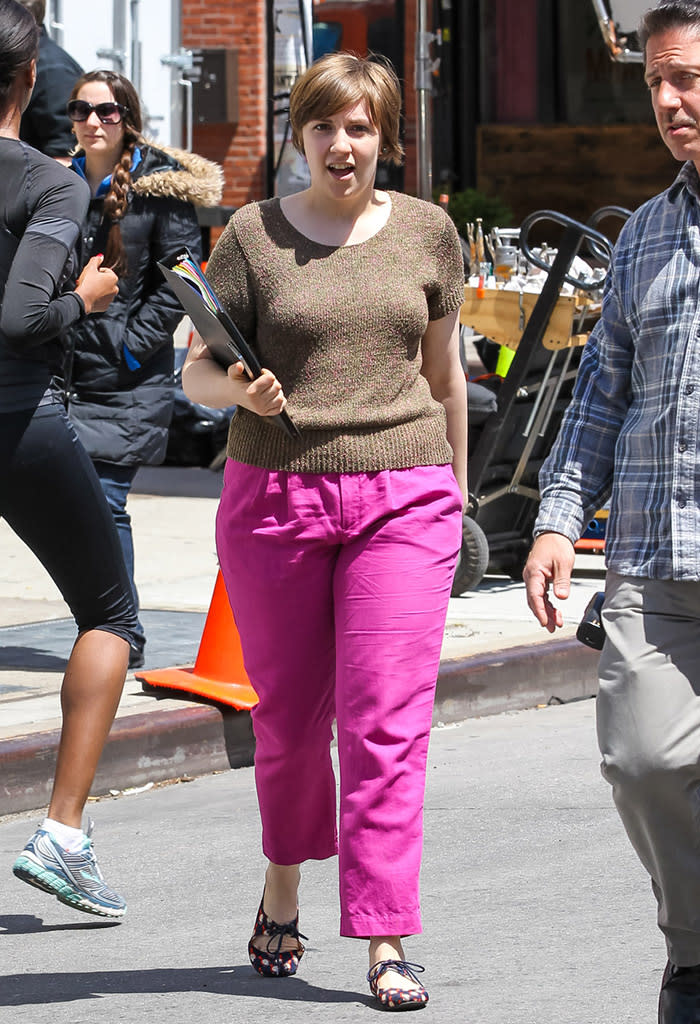 A bra-less Lena Dunham, seen holding a binder, gets back to filming for HBO's third season of 'Girls' in New York City