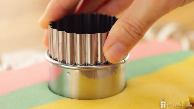 Rainbow Sandwich Cookies baking process of cutting dough into round shapes