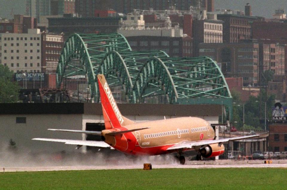 The downtown Kansas City skyline and the Buck O’Neil Bridge served as a background as a Southwest Airlines jet makes an unexpected landing at the downtown airport during a rainstorm in 1998.