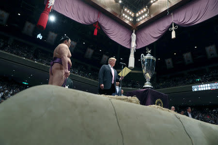 U.S. President Donald Trump prepares to present the President’s Cup to wrestler Asanoyama, the winner of the Summer Grand Sumo Tournament at Ryogoku Kokigikan Sumo Hall in Tokyo, Japan May 26, 2019. REUTERS/Jonathan Ernst