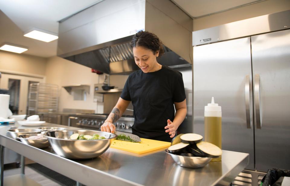 LesbiVeggies owner Brennah Lambert prepares eggplant parmesan and spaghetti in her plant-based and gluten-free Audubon café that is slated to open in February.  