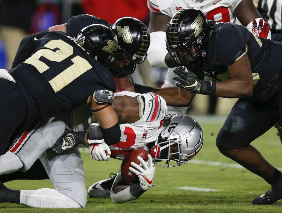 Purdue defenders bring down Ohio State running back Mike Weber on Oct. 20, 2018.