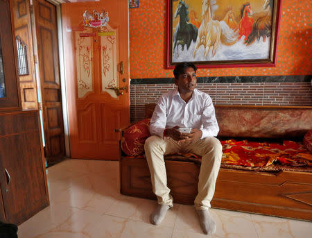 Sachin Bhadrasen Jaiswar, a survey-taker for the Centre for Monitoring Indian Economy (CMIE), talks to a family as he conducts a survey in a neighbourhood in Mumbai, India, September 2, 2016. REUTERS/Shailesh Andrade