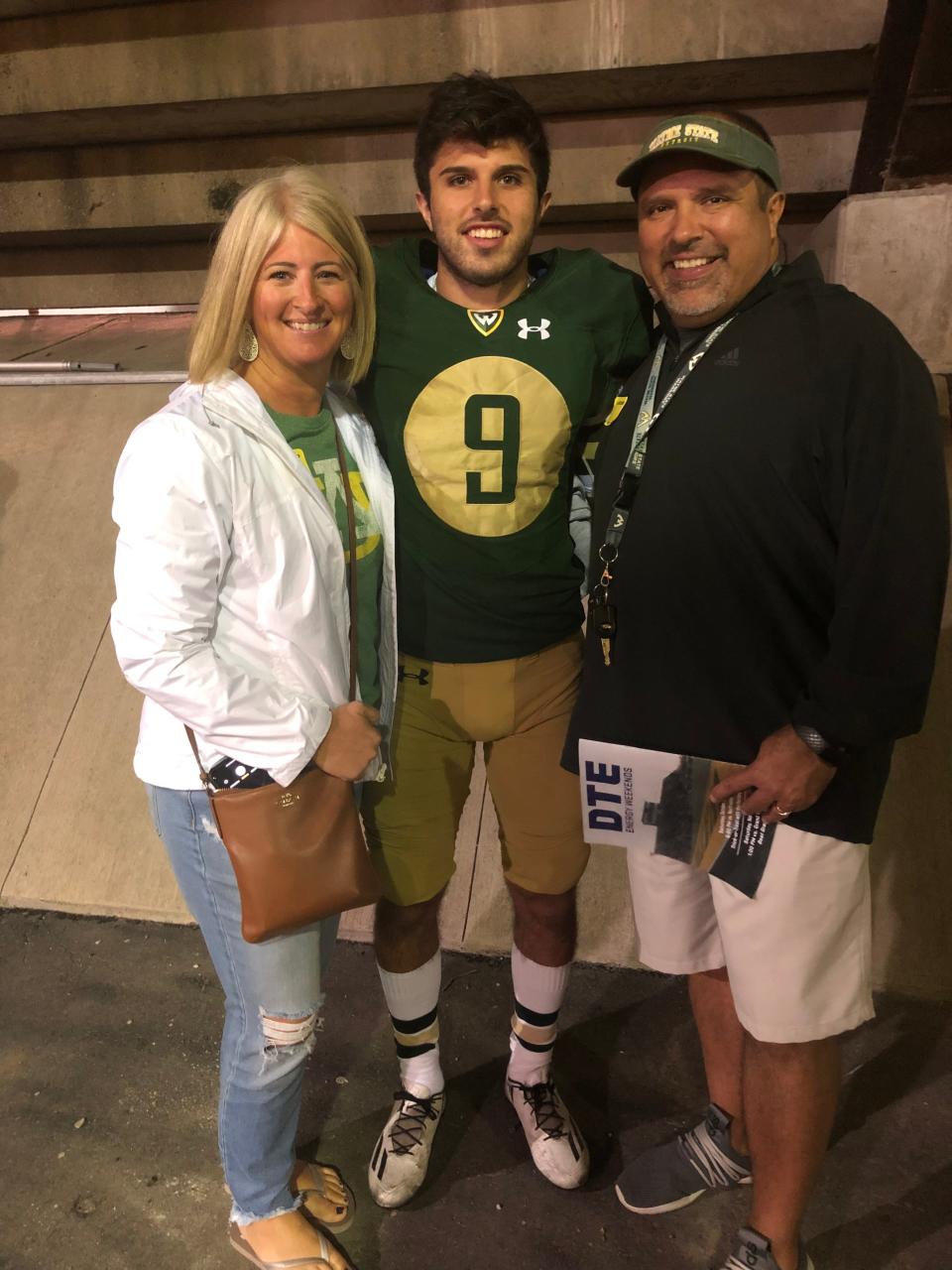 Brady Hessbrook poses with his Kristy, left, and Terry, right, after a Wayne State football game.