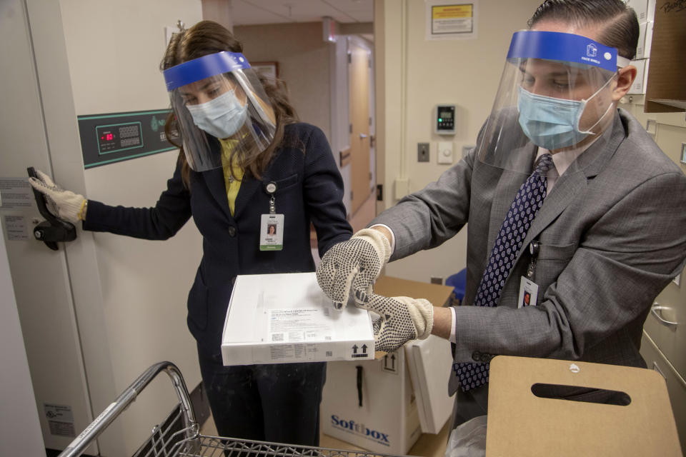 Nancy Palamara and Joseph Cruz accepted the vaccine and stored it in the 80 degree below zero freezer. (Jeff Rhode/Holy Name Medical Center)