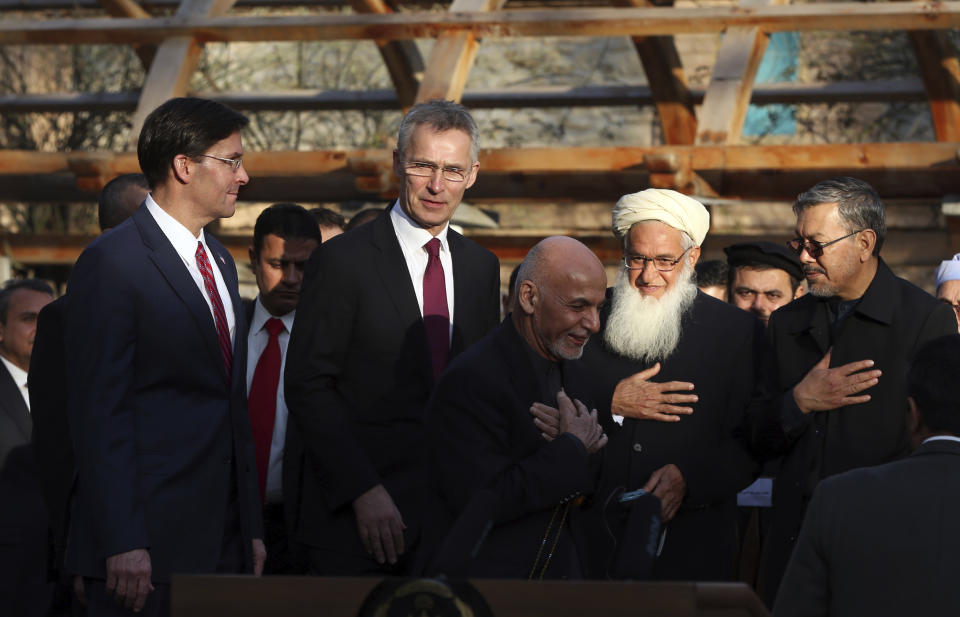 FILE- In this Feb. 29, 2020 file photo, Afghan President Ashraf Ghani, center, arrives with NATO Secretary General Jens Stoltenberg, second left, and U.S. Secretary of Defense Mark Esper, left, for a joint news conference after the US signed a peace agreement with Taliban militants, at the presidential palace in Kabul, Afghanistan. President Joe Biden is reviewing his predecessor's 2020 deal with the Taliban, which includes a May 1, 2021, deadline for a final U.S. troop withdrawal from the war-ravaged country. (AP Photo/Rahmat Gul, File)