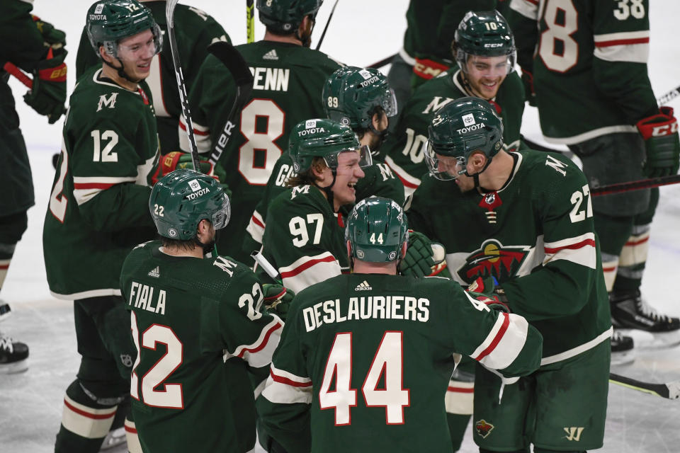 Minnesota Wild left wing Kirill Kaprizov (97) celebrates with his teammates after his overtime goal against Calgary Flames goalie Jacob Markstrom in an NHL hockey game Thursday, April 28, 2022, in St. Paul, Minn. (AP Photo/Craig Lassig)