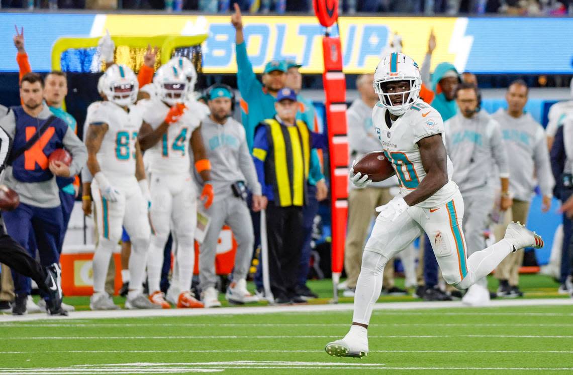 Miami Dolphins wide receiver Tyreek Hill (10) runs to score a touchdown after picking up a fumble by Miami Dolphins running back Jeff Wilson Jr. (23) in the second quarter during the game against the Los Angeles Chargers at SoFi Stadium in Inglewood, California on Sunday, December 11, 2022.