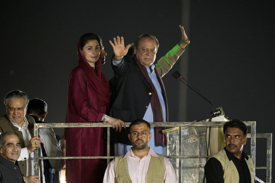 Pakistan's former Prime Minister Nawaz Sharif, center waves to his supporters upon his arrival to address a welcoming rally, in Lahore, Pakistan, Saturday, Oct. 21, 2023. Sharif returned home Saturday on a special flight from Dubai, ending four years of self-imposed exile in London as he seeks to win the support of voters ahead of parliamentary elections due in January. (AP Photo/Anjum Naveed)