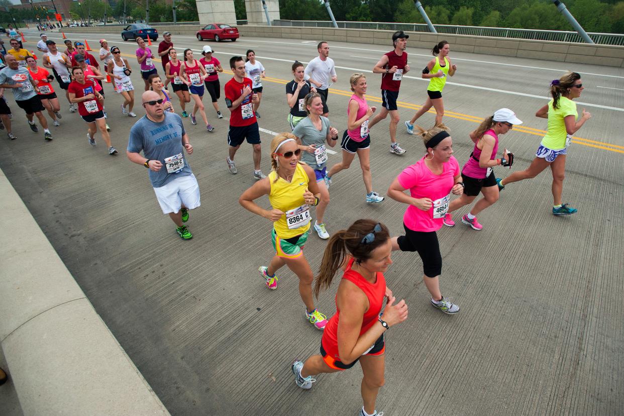 Participants in the Capital City Half Marathon make their way across the Lane Avenue Bridge in 2012. The race will be returning in person Saturday after going virtual for the pandemic.