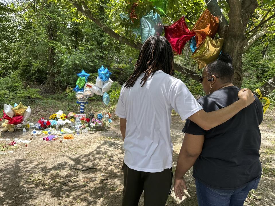 Mourners stop by a memorial to Cyrus Carmack-Belton on Thursday, June 1, 2023, in Columbia, S.C. Authorities said Carmack-Belton, 14, was shot and killed by a store owner who wrongly suspected him of shoplifting. (AP Photo/Jeffrey Collins)