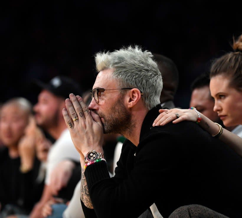 Adam Levine with wife at basketball game