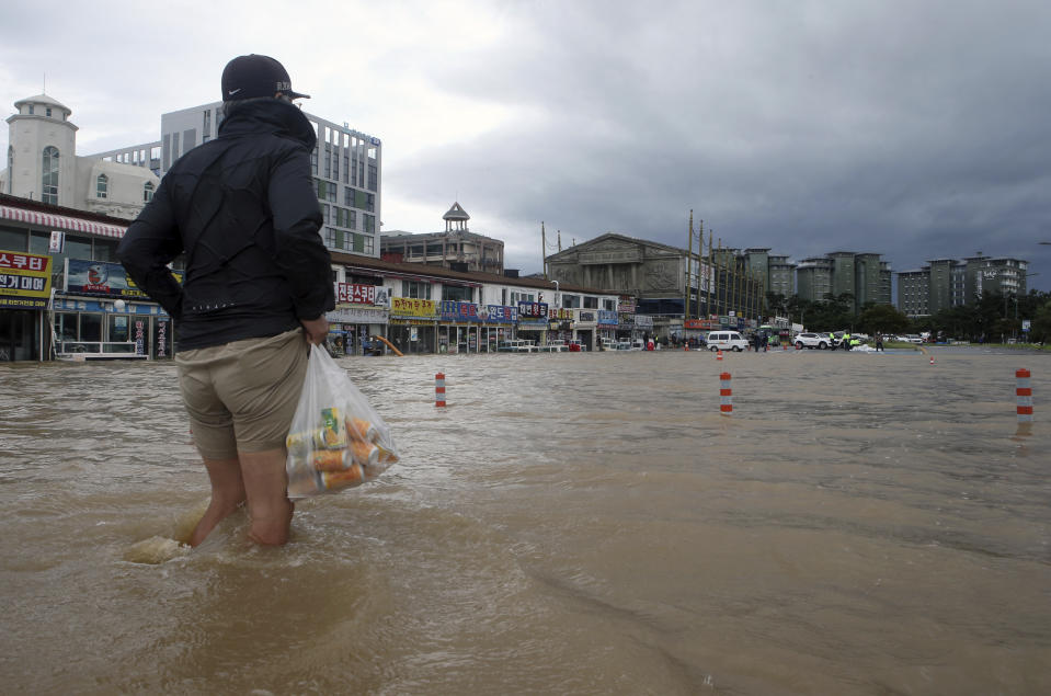 A citizen walks through a flooded area in Gangneung, South Korea, Thursday, Sept. 3, 2020. A powerful typhoon ripped through South Korea’s southern and eastern coasts with tree-snapping winds and flooding rains Thursday, knocking out power to thousands of homes. (Lee Hae-yong/Yonhap via AP)