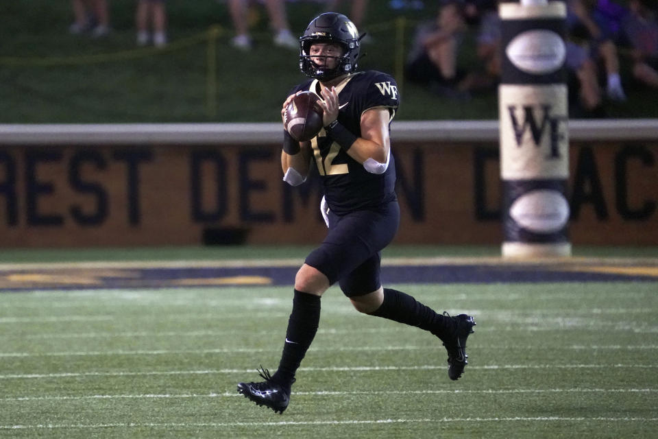 FILE - Wake Forest quarterback Mitch Griffis (12) scrambles against VMI during the first half of an NCAA college football game in Winston-Salem, N.C., Sept. 1, 2022. Wake Forest opens the season against Elon on Aug. 31, 2023. (AP Photo/Chuck Burton, File)