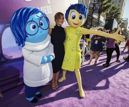 Cast member Amy Poehler (C) poses with the characters of Sadness and Joy (R) at the premiere of "Inside Out" at El Capitan theatre in Hollywood, California June 8, 2015. The movie opens in the U.S. on June 19. REUTERS/Mario Anzuoni