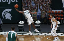 Michigan State's Mady Sissoko (22) leaps for a rebound as Eastern Michigan's Ty Groce (1) and Michigan State's Malik Hall, right, watch during the second half of an NCAA college basketball game Wednesday, Nov. 25, 2020, in East Lansing, Mich. Michigan State won 83-67. (AP Photo/Al Goldis)