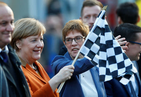 Annegret Kramp-Karrenbauer, State Minister-President and top candidate of the Christian Democratic Union Party (CDU) and German Chancellor Angela Merkel attend an election rally for the upcoming state elections in the Saarland, in St. Wendel near Saarbruecken, Germany March 23, 2017. REUTERS/Ralph Orlowski