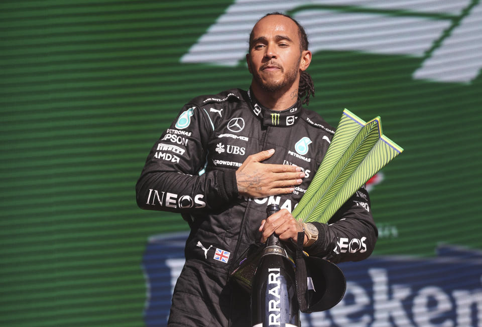 Mercedes driver Lewis Hamilton, of Britain, celebrates his first place victory in the Brazilian Formula One Grand Prix in Sao Paulo, Brazil, Sunday, Nov. 14, 2021. (Lars Baron, Pool Photo via AP)