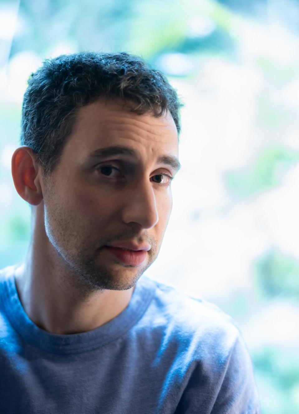 Man posing in blue shirt