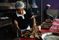 <p>At Mzoliâs Buthcery, a cook seasons the meat. In the tray is the portion, ordered by two people during the braai (a tipical South African BBQ). Mzoli’s a “do-it-yourself” market and eatery is located in the township of Gugulethu, a black neighbourhood 9 miles southeast of the center of Cape Town.<br> South Africa consumes about 2.9 million tons of poultry, beef and pork meat per year. (Photograph by Silvia Landi) </p>