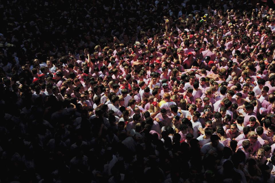 Revelers pack the town hall square before the 'Chupinazo', the official opening of the 2012 San Fermin fiestas, Friday, July 6, 2012 in Pamplona, Spain. Revelers from around the world kick off the San Fermin festival with a messy party in the Pamplona town square, one day before the first of eight days of the running of the bulls. (AP Photo/Daniel Ochoa de Olza)