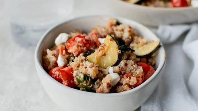 Quinoa zucchini salad in white bowl