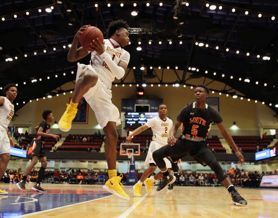 Mt. Vernon's Irvin Patrick (1) pulls down a rebound in front of White Plains' Jayon Norwood (5) during the boys Class AA basketball semifinal at the Westchester County Center in White Plains  Feb. 27,  2019. Mt. Vernon won the game 62-48.