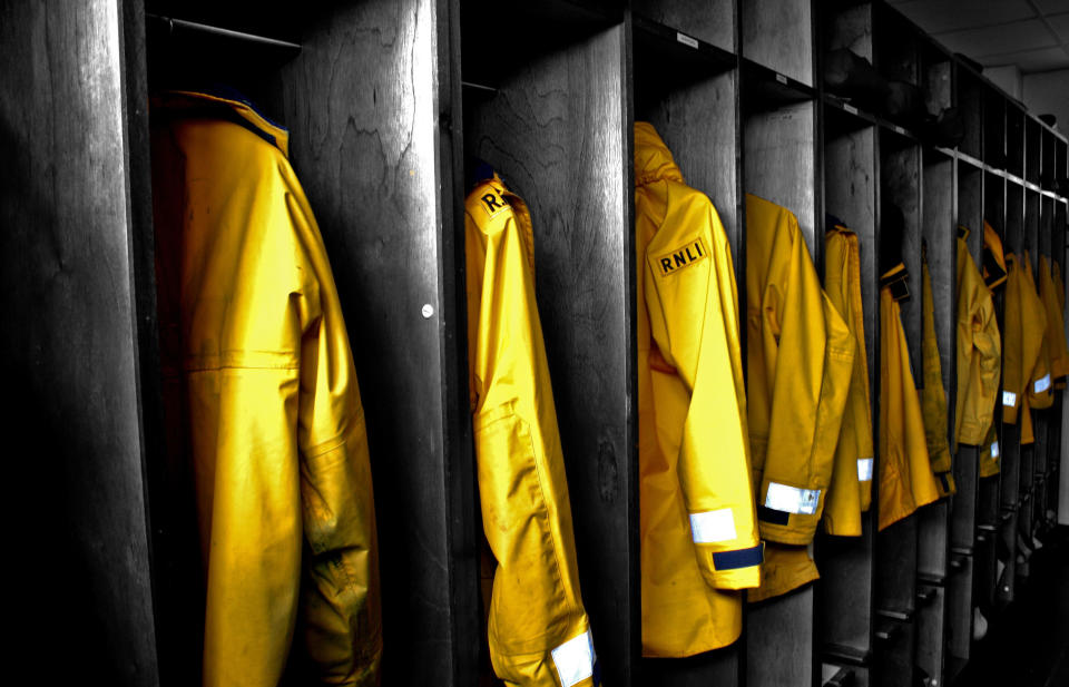 First place winner 'The Calm' by Neville Murphy. Luminous yellow coats are hung in cubby holes in Dunmore East, Ireland (Neville Murphy/Rex Features)