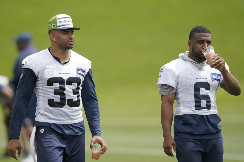 Seattle Seahawks strong safety Jamal Adams (33) and free safety Quandre Diggs (6) walk on the field during NFL football practice Tuesday, June 7, 2022, in Renton, Wash. (AP Photo/Ted S. Warren)