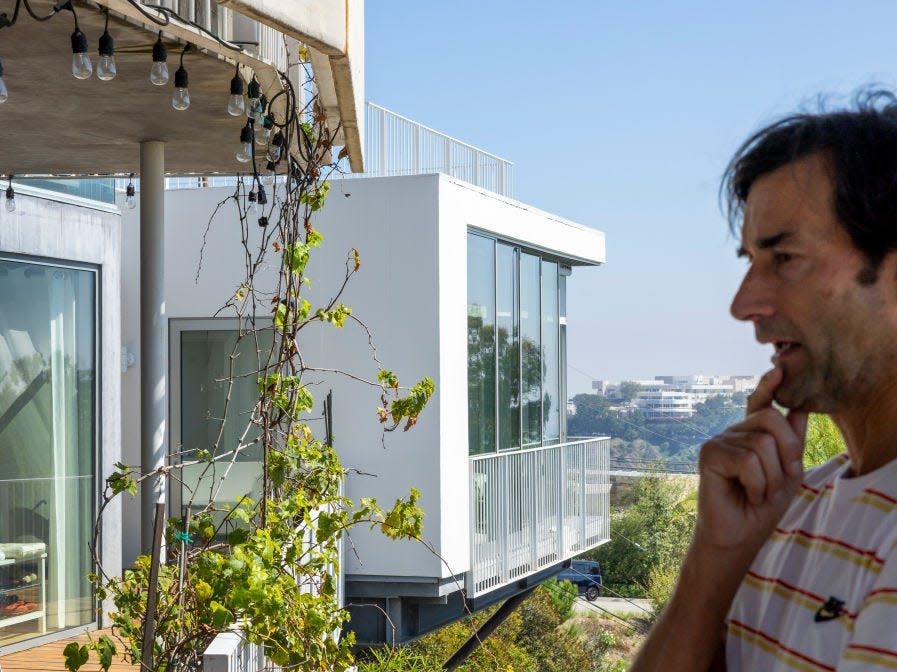 Aleksandar Jovanovic, a Airbnb landlord, stands on the deck of his Los Angeles home.